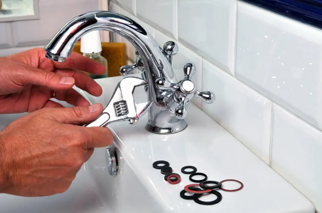 Plumber performing maintenance on a bathroom faucet in Fountain