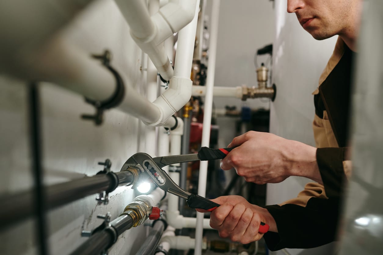 Plumbers maintaining commercial plumbing pipes in Fountain