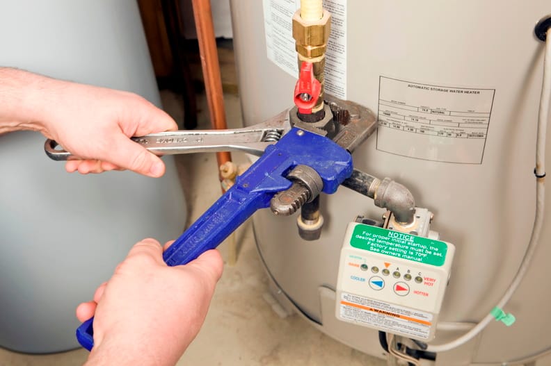 Plumber repairing a water heater valve in Fountain